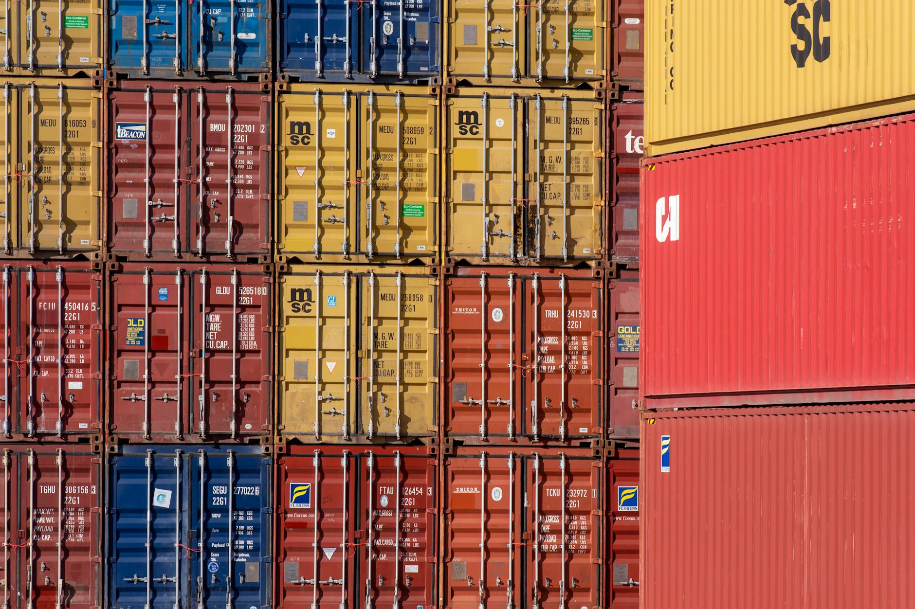 stacked shipping containers in a port